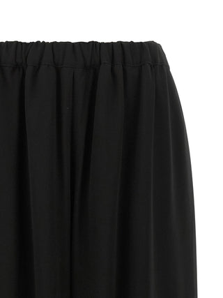 Black wool casual pants by Comme Des Garçons with a relaxed fit, featuring a smooth waistband and tailored design.
