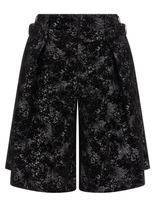 Black polyester Bermuda shorts by Comme Des Garçons, featuring a relaxed fit and knee-length design for casual wear.