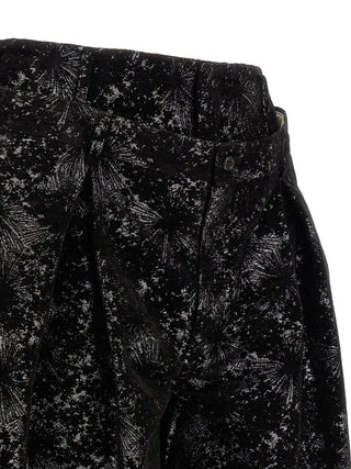 Black polyester Bermuda shorts by Comme Des Garçons, featuring a relaxed fit and clean design, shown on a plain background.