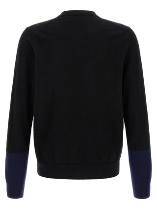 Black wool cardigan by Comme Des Garçons with a relaxed fit, featuring a soft texture and classic button closure.