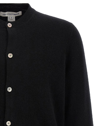 Black wool cardigan by Comme Des Garçons featuring a classic knit design and button closure.