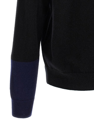 Black wool cardigan by Comme Des Garçons, featuring a classic knit design and button closure, displayed on a neutral background.