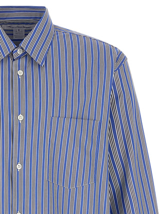 Blue cotton blouse by Comme Des Garçons, featuring a relaxed fit and classic collar, displayed on a hanger.