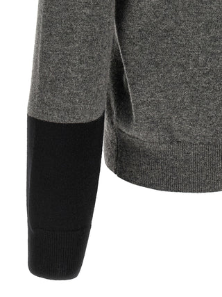 Gray wool cardigan by Comme Des Garçons, featuring a soft knit texture and classic design, displayed on a hanger.