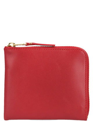 Red calfskin cardholder from Comme Des Garçons with multiple card slots and sleek, minimalist design.