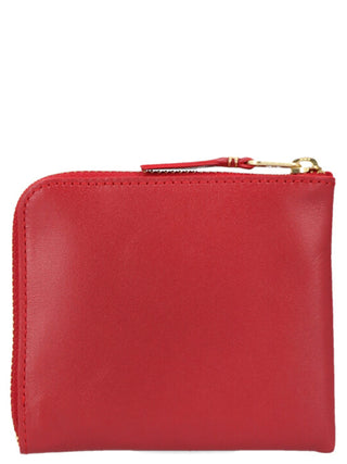 Red calfskin cardholder from Comme Des Garçons with multiple card slots and sleek, minimalist design.