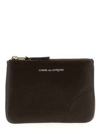 Brown calfskin cardholder by Comme Des Garçons with multiple card slots and sleek minimalist design.