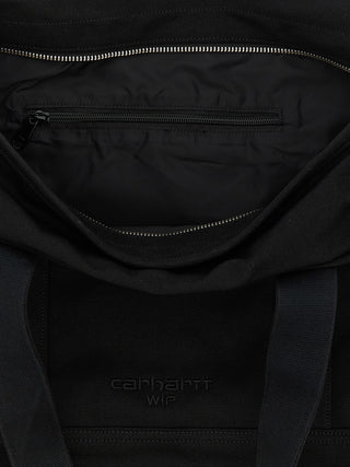 Black cotton tote bag by Carhartt Wip with sturdy handles and minimal branding, perfect for daily use and carrying essentials.