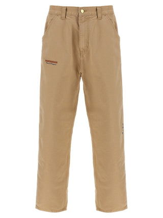 Beige organic cotton casual pants by Carhartt Wip, featuring a relaxed fit with front pockets and a comfortable waistband.