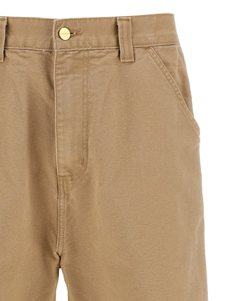 Beige organic cotton casual pants by Carhartt Wip showing relaxed fit and soft fabric texture.