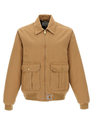 Beige Carhartt Wip cotton full-length jacket with a collar and front pockets, displayed hanging on a hanger.