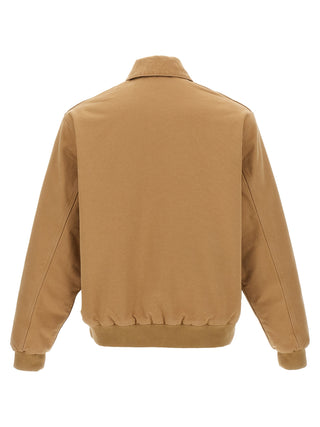 Beige Carhartt Wip cotton full-length jacket with front pockets and button closure, displayed on a hanger.