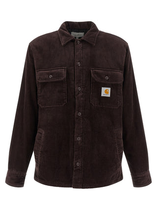 Carhartt Wip brown cotton jacket shown on a hanger, featuring a classic design with front pockets and a button-up front.