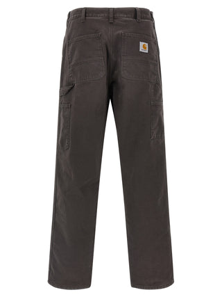 Brown organic cotton casual pants by Carhartt Wip, featuring a relaxed fit and classic design, displayed on a neutral background.