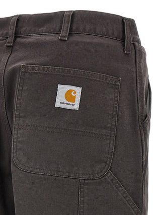 Carhartt Wip brown organic cotton casual pants with a relaxed fit and functional pockets, designed for everyday comfort.