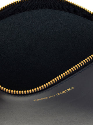Blue cowhide cardholder by Comme Des Garçons featuring a sleek design and multiple card slots.