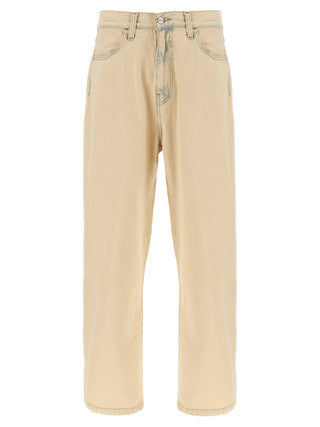 Beige Carhartt Wip cotton straight-leg jeans hanging on a wooden hanger, showcasing classic casual style and durable fabric.