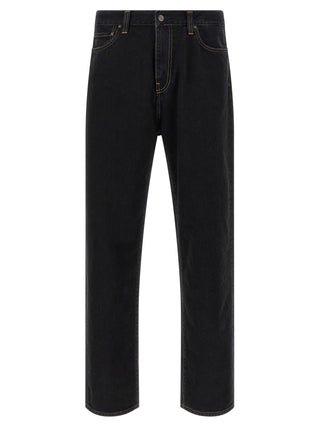 Black Carhartt Wip cotton tapered jeans with classic five-pocket design and relaxed fit, shown on a model.
