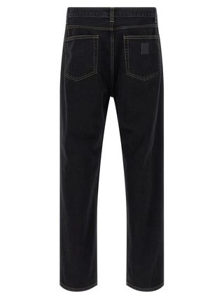 Black Carhartt Wip cotton tapered jeans with a slim fit, front pockets, and classic stitching, displayed on a neutral background.