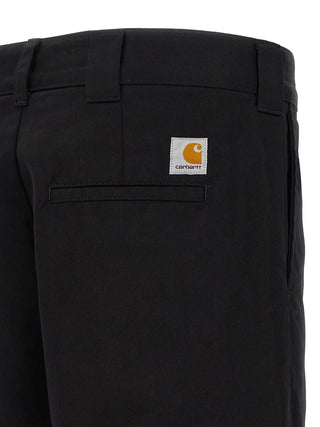 Black polyester casual pants by Carhartt Wip, featuring a relaxed fit and functional design, shown in the product image.