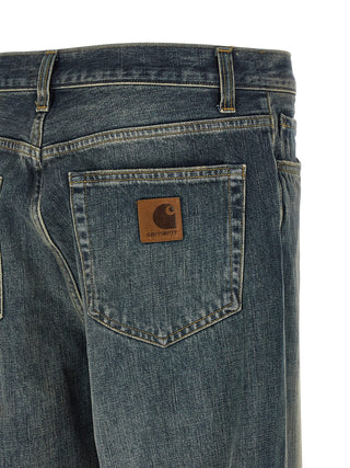 Gray Carhartt Wip cotton straight-leg jeans displayed on a hanger, showing the classic fit and denim texture.