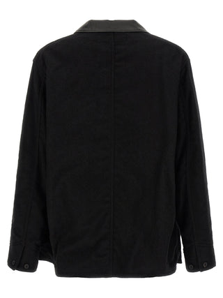 Black wool full-length jacket by Comme Des Garçons, showcasing a sleek, tailored design with a classic collar and smooth fabric finish.