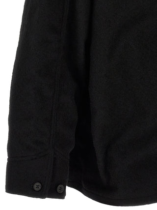 Black wool full-length jacket by Comme Des Garçons, showcasing a tailored design with a collar and button closure.