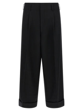 Black wool cropped pants by Comme Des Garçons, featuring a tailored fit and stylish design, shown on a model.