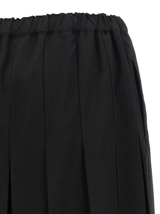 Black wool casual pants by Comme Des Garçons featuring a relaxed fit and minimalist style.