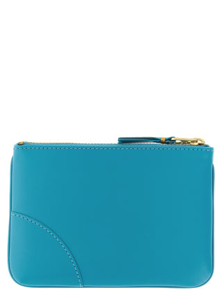 Blue calfskin cardholder by Comme Des Garçons with multiple card slots and sleek design.