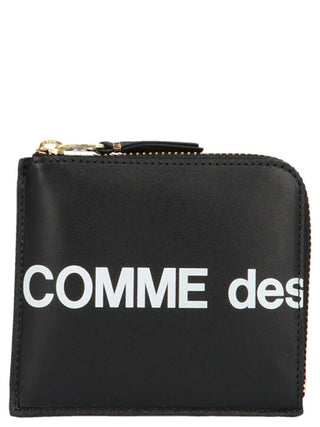Black cowhide cardholder by Comme Des Garçons with multiple card slots and sleek minimalist design.