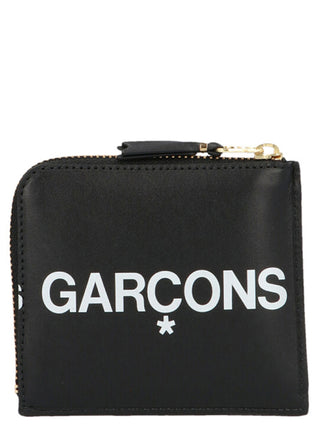Black cowhide cardholder by Comme Des Garçons featuring sleek leather design and multiple card slots.