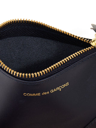 Blue calfskin cardholder by Comme Des Garçons featuring a sleek, minimalist design with multiple card slots.