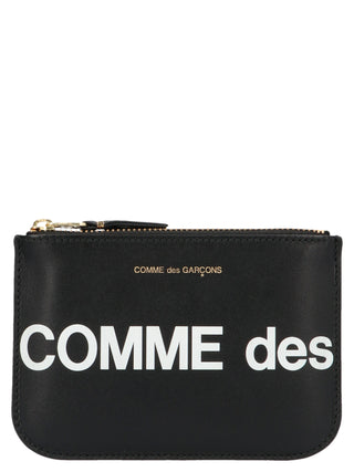Bicolor calfskin cardholder by Comme Des Garçons with sleek design and multiple card slots, in black and white leather.