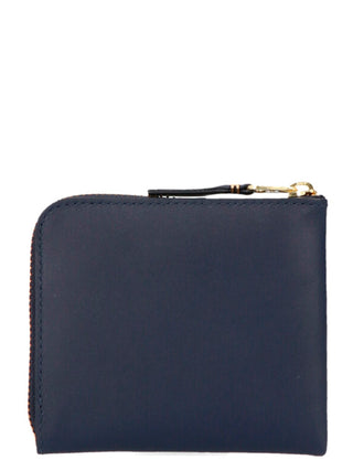 Blue calfskin wallet from Comme Des Garçons with a sleek, minimalist design and subtle branding, shown open to reveal card slots.