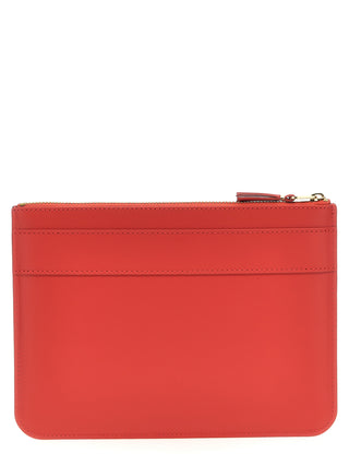 Red cowhide cardholder by Comme Des Garçons with multiple card slots and sleek design.