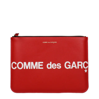 Red leather clutch bag by Comme Des Garçons with sleek design and minimalistic style, perfect for evening or casual use.