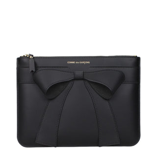 Black leather clutch bag by Comme Des Garçons with sleek design and minimalist style, featuring a fold-over flap and subtle logo detail.