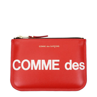 Red leather cardholder by Comme Des Garçons showing multiple card slots and sleek design.