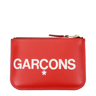 Red leather cardholder from Comme Des Garçons with multiple card slots and sleek minimalist design.