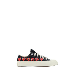 Black canvas low top sneakers from Comme Des Garçons Play x Converse, featuring classic lace-up design and white rubber soles.