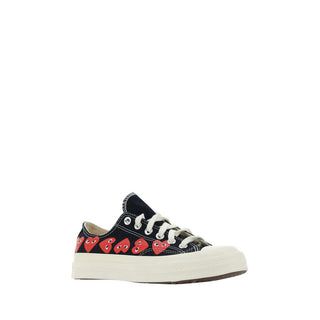 Black canvas low top sneakers by Comme Des Garçons Play x Converse featuring white rubber soles and classic sneaker design.