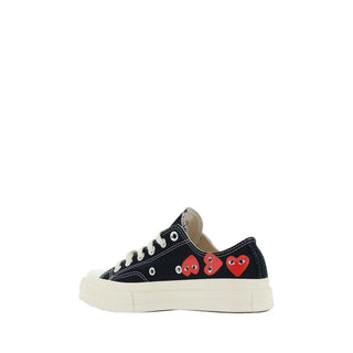 Black canvas low-top sneakers from Comme Des Garçons Play x Converse, featuring classic design and white rubber soles.