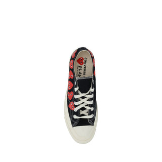 Black canvas low top sneakers from Comme Des Garçons Play x Converse with white rubber soles and classic lace-up design.