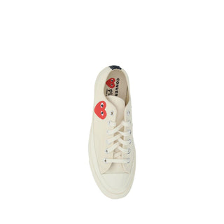 White cotton low top sneakers by Comme Des Garçons Play x Converse, featuring classic design and branding details.
