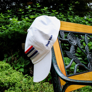 Dark Yarn Nautilus Reserve Dockside Cap, navy blue headwear with logo embroidery, casual style, worn on a wooden dock background