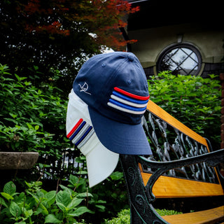 Dark Yarn Nautilus Reserve Dockside Cap, stylish headwear with a nautical-inspired design and adjustable strap, shown on a model.