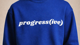 Blue sweatshirt with 'progress(ive)' text on a beige background