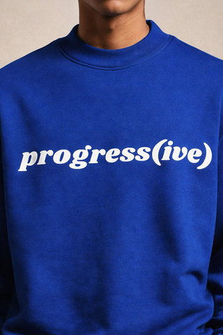 Blue sweatshirt with 'progress(ive)' text on a neutral background